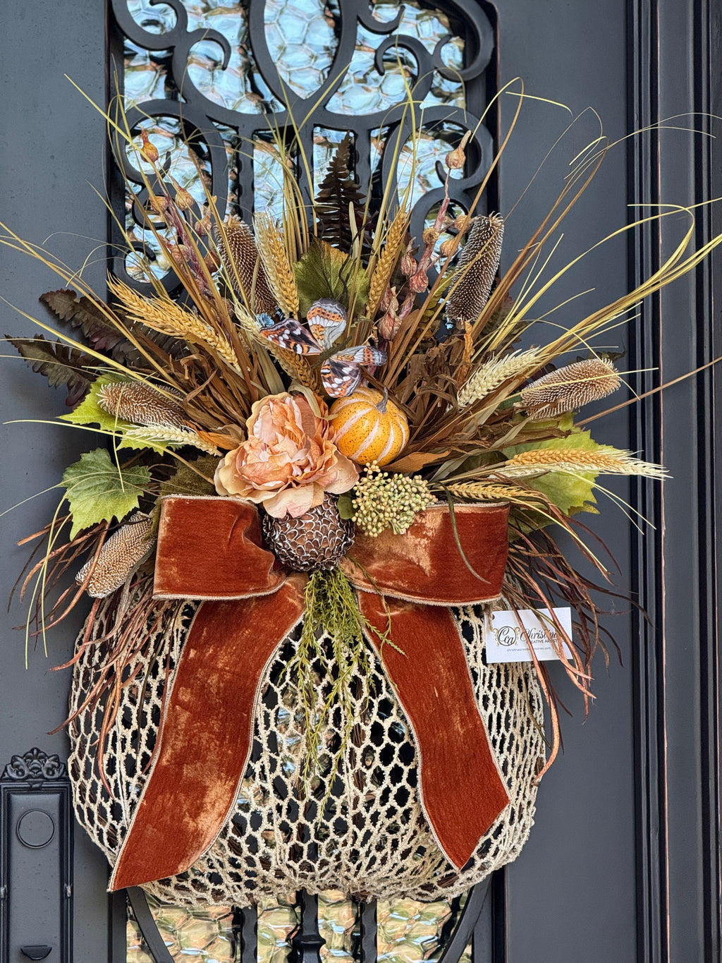 Decorative wreath with autumnal elements on a door