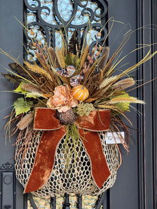 Decorative wreath with autumnal elements on a door