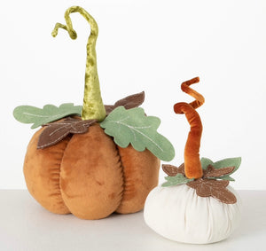 Plush Pumpkins product image features a set of two pumpkins.  One 10-inch high  cream pumpkin, one 14-inch high orange pumpkin.  Fall colors: cream, brown, green and orange.  Made with polyester and felt.  Sold as a set of 2.