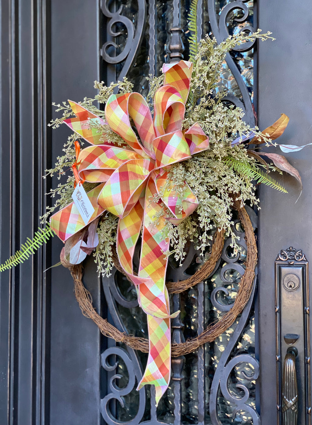 Berry Fall Wreath product image features a fall wreath.  Berry stems, seeded eucalyptus stems, fall fern picks, double ring grapevine and a large, multi-colored bow.  Colors are brown, cream , shades of orange, yellow and green.  Measures 40"H X 23"W. Comes ready to hang on a nail, hook or door hanger.Faux.  Indoor outdoor use.
