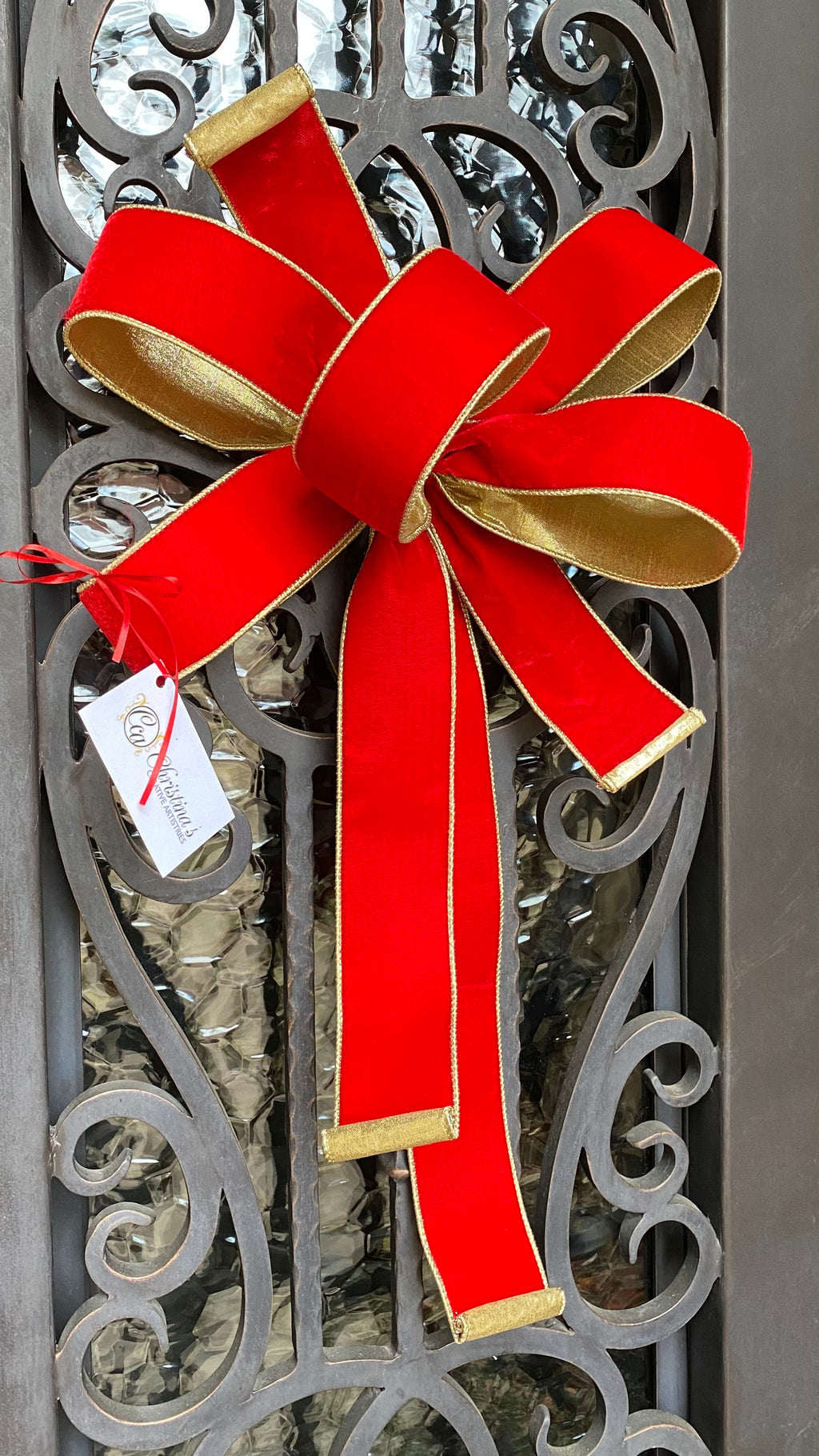 Red Bow product image.  Features wired ribbon.   Hot red lush velvet lined with a light gold metallic backing.  Measures 15"W X 25.5"H.  Comes with tie attached.