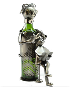 Male Hairdresser Wine Bottle Buddy product image features a male hairdresser cutting the hair of a child sitting on a stool and reading a book.  All made of recycled metal.  Color is nickel.  Great Father's Day gift. Comes gift wrapped.   Bottle not included.