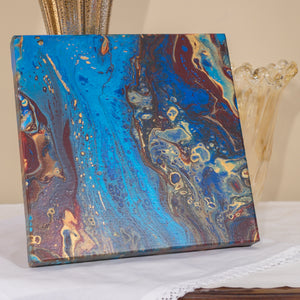 Pacific Jewel by Christina Russell features original artwork.  One-of-a-kind .  Acrylics in dark red, gold and metallic blue.  Measures 12” x12”.  Wrapped Canvas.  Modern. Comes ready to hang