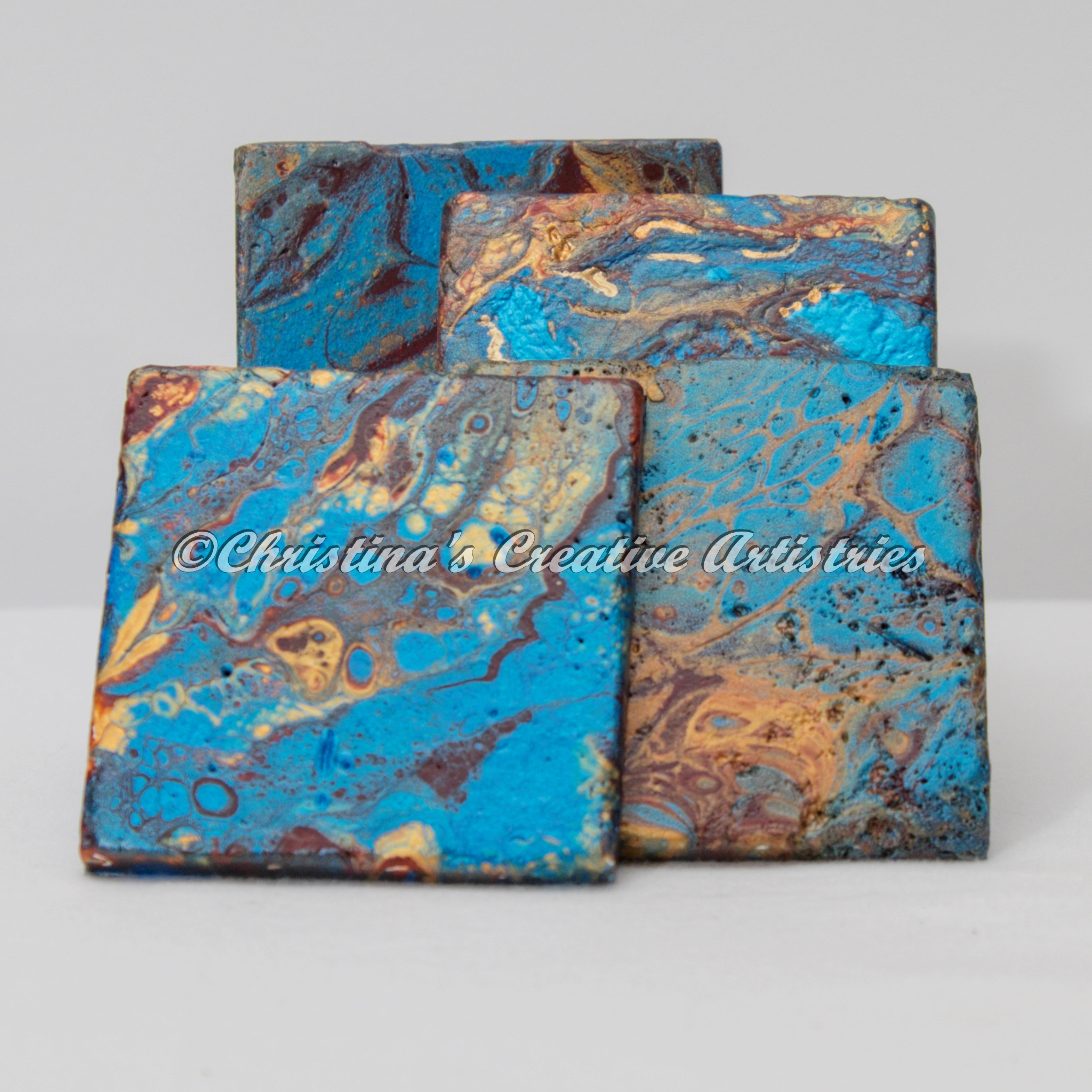 Pacific Jewel Stone Coasters product image features one set of four stone coasters.  Hand painted.  Fluid contemporary design.  Colors: teal, gold wine.  Cork backed