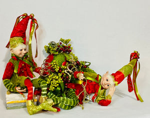 Festive Poseable Elves product image features 15" elves.  Red and green clothing with gold accents. They have bendable legs and arms making it easy to pose them.  Polyester clothing.  Resin face and hands. lifelike, stylish, fun and unique Christmas decorations.  For decorative use only.