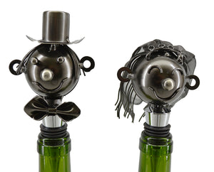 Bride and Groom metal bottle stopper set.  The bride has shoulder length metal mesh vail.  The groom has on a bowtie and top hat.