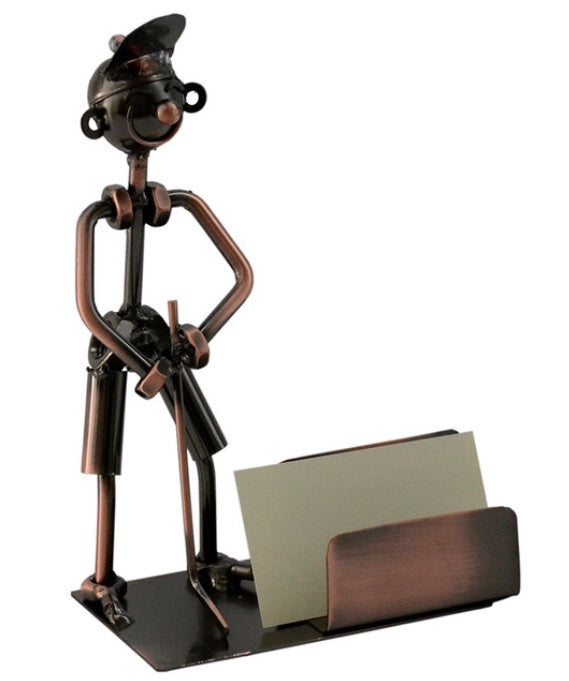 Golfer Business Card Holder product image features a golfer wearing a cap, holding a putter, standing next to a business card holder.  Color is bronze.  Material is recycled metal.  Handcrafted. Unique. Decorative. Fun gift for golf enthusiast.  Great desk top accessory.  Unique Father's Day Gift. Color is bronze. Holds up to 100 business cards.  Comes gift wrapped for Father's Day.