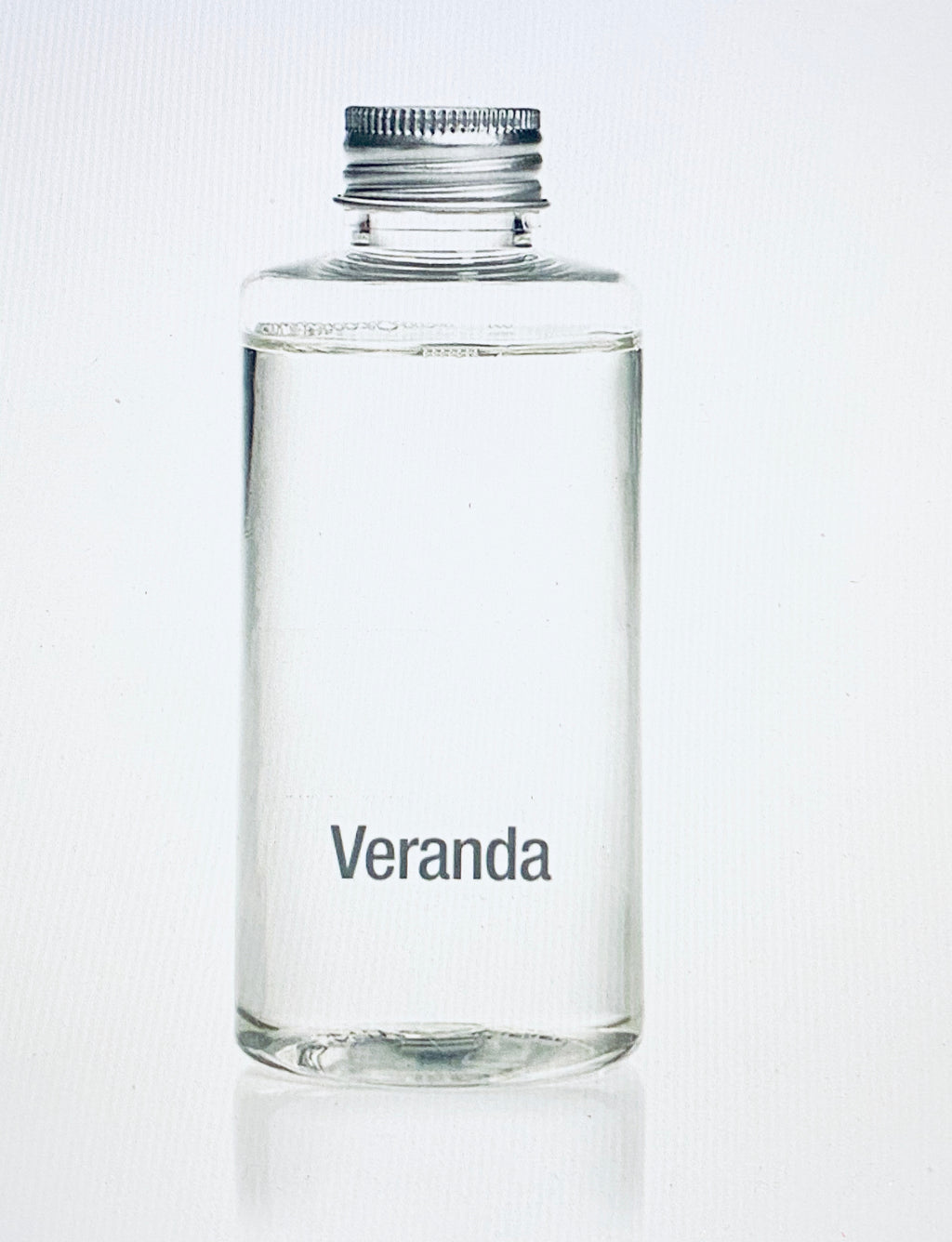 Veranda French Gardenia Porcelain Diffuser Refill product image features a 100ml clear glass bottle filled with french gardenia oil fragrance.  Veranda line of home fragrances in Zodax brand.  The fragrance top notes are fresh bergamot and watery bamboo.  The middle notes are french gardenia, white tuberous and star jasmine.  The base notes are creamy sandalwood, white amber and exotic musk.  Aroma is clean, soft and floral.