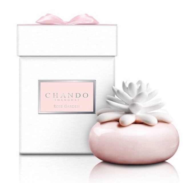 Chando Elegance Collection- Rose Garden Fragrance product image features elegant packaging. A soft pink, polished porcelain vase, unglazed dandelion flower diffuser, 100ml bottle of Rose Garden fragrance, one plastic funnel.  Fragrance is alcohol free and has the aroma of roses with a hint of freesia.  Elegant and unique.  Fabulous gift for mom, sister, party hostess.  Great housewarming gift.    