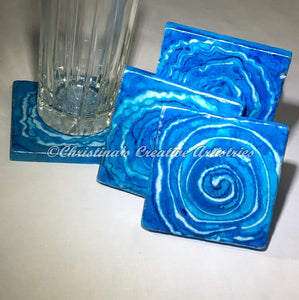 Blue Wave 2 feastures hand painted coasters by Christina Russell.  4”x4” botticino marble.  Colors are blue, white with hints of silver. Cork backed.  Sold in sets of 4.  Iron coaster stand included.  Make great corporate gifts, housewarming gift, wedding gift.  Contemporary decor,  Modern decor.  Tabletop decor.