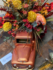 Up close image of Orange Truck Fall Floral  arrangement.