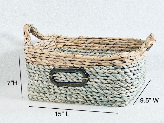 Straw Basket Set product image features the medium of 3 baskets in the set.  Material: natural straw.  Color: Dusty blue and natural.  Size:15"L X 9.5"W X 7"H