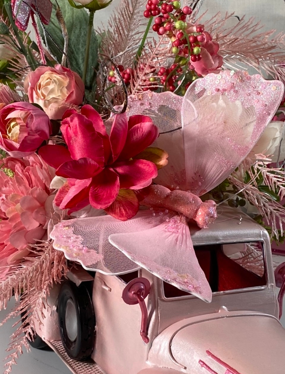 Pink Truck Floral Arrangement product image features a close up image of the pink butterfly and some of the florals in the arrangement.