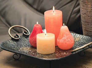 This images shows Timber Pear candles in coral,  melon white and cranberry grouped on a  square metal tray.