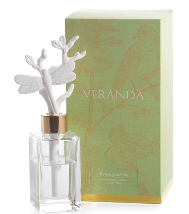 Zodax Veranda Dragonfly Porcelain Diffuser product image features a clear glass bottle filled with 80 ml of french gardenia oil fragrance and a dragonfly porcelain diffuser insert.   Bottle dimension is 3.25" X 7.5".  Allow 24-36 hours for full fragrance effect. Fragrance refills available in store.